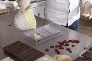 Pouring White Chocolate into Polycarbonate Mold